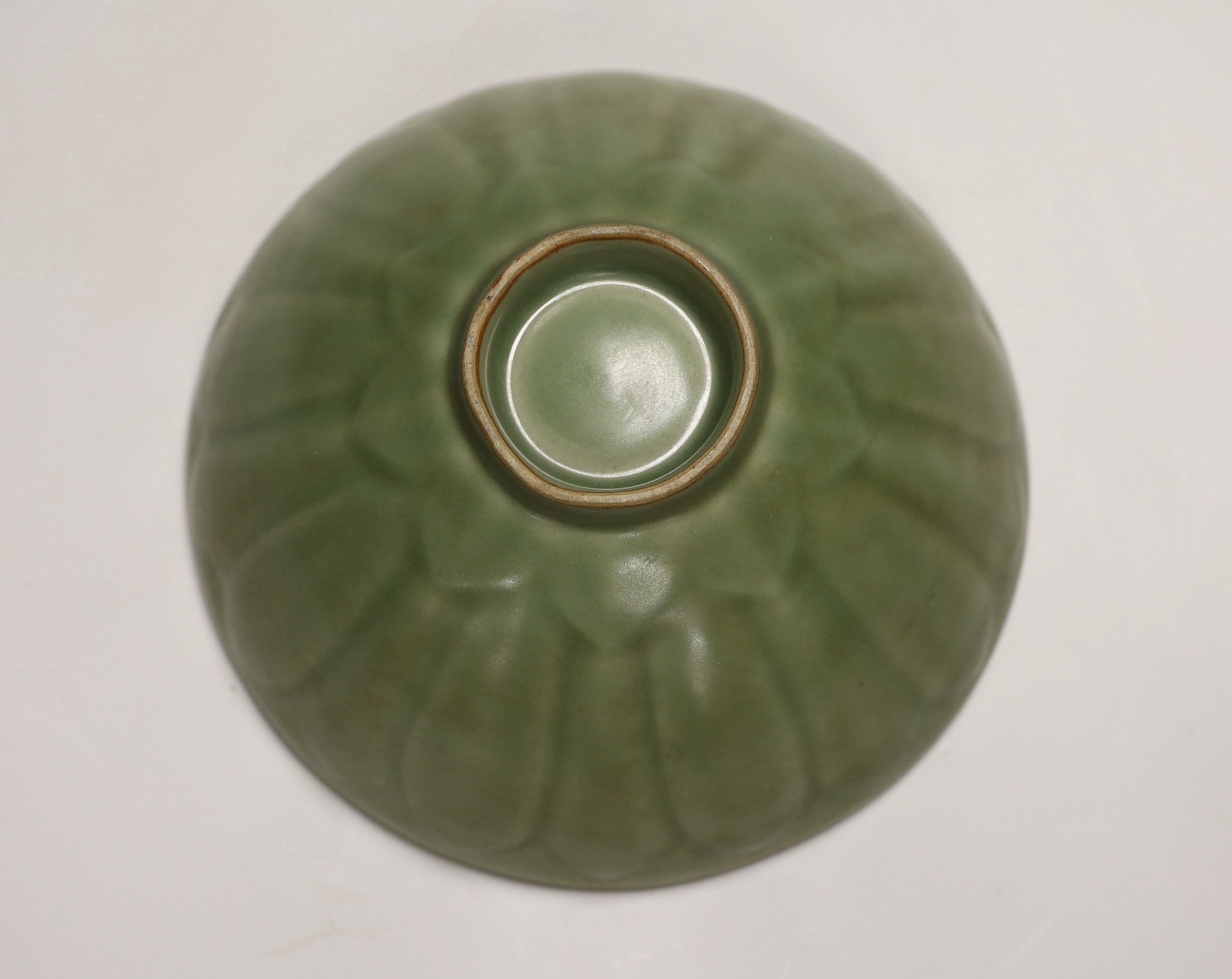 A Chinese celadon ground ‘lotus’ bowl, 21cm diameter